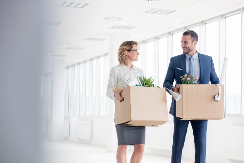 Business-people-walking-while-carrying-box-and-relocating-to-new-office.jpg