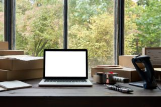 E commerce business laptop on desk. Why e-commerce businesses can use a commercial storage unit.