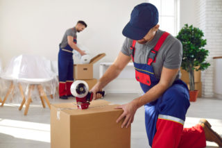 Commercial moving employee performing additional moving services, like packing.