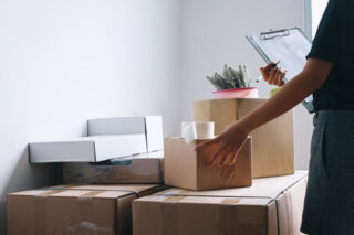 Woman checking and packing the carton box prepare to move